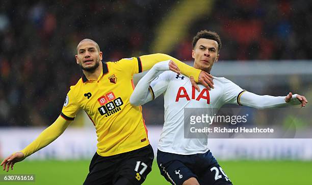 Dele Alli of Tottenham Hotspur tangles with Adlene Guedioura of Watford during the Premier League match between Watford and Tottenham Hotspur at...