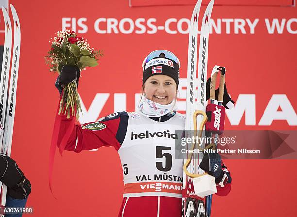 Ingvild Flugstad Oestberg of Norway celebrates after the victory during the women's 5 km C mass start race on January 1, 2017 in Val Mustair,...