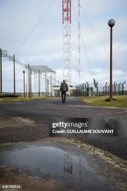 Man walks by the TDF radiobroadcaster transmitter antenna of 350 meters meters high in Allouis near Vierzon, central France, on December 23 after...