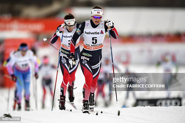 Norway's Ingvild Flugstad Oestberg leads the race ahead of compatriot Heidi Weng, on their way to finish respectively first and second of the women's...