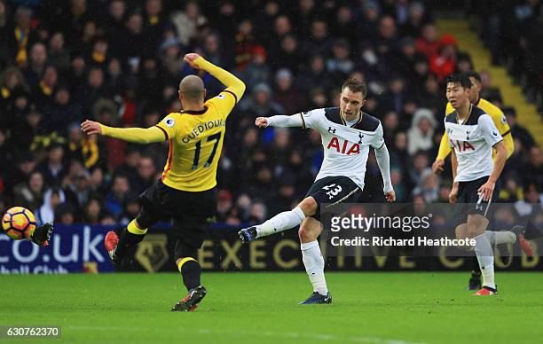 Christian Eriksen of Tottenham Hotspur shoots past Adlene Guedioura of Watford during the Premier League match between Watford and Tottenham Hotspur...