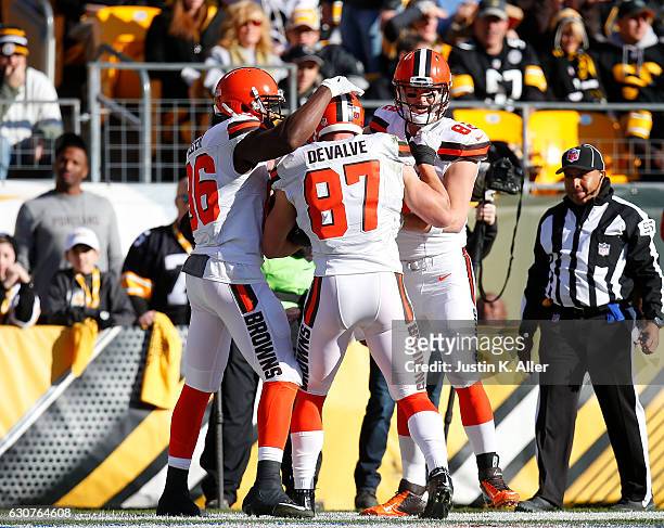 Seth DeValve of the Cleveland Browns celebrates his 12 yard touchdown reception with Gary Barnidge and Randall Telfer in the first quarter during the...