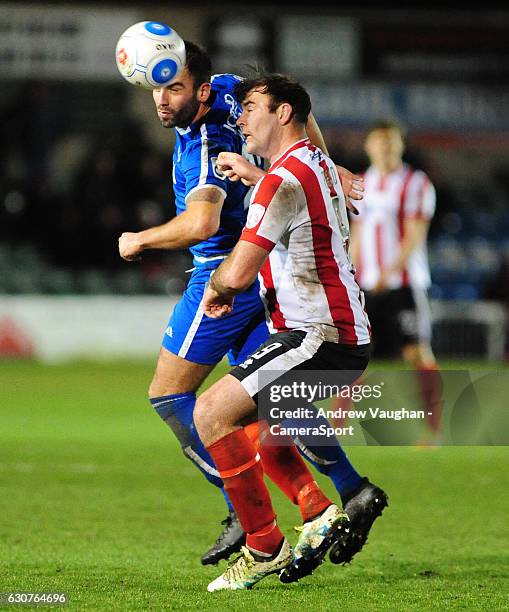 Lincoln City's Matt Rhead vies for possession with Guiseleys Simon Walton during the Vanarama National League match between Lincoln City and Guiseley...