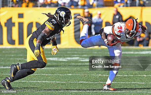 Isaiah Crowell of the Cleveland Browns goes airborne as he rushes against Jarvis Jones of the Pittsburgh Steelers in the first half during the game...