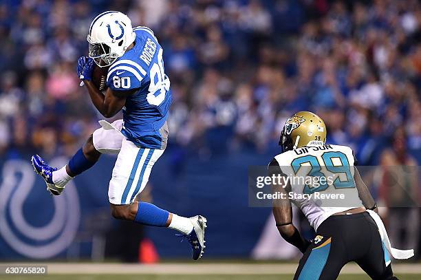 Chester Rogers of the Indianapolis Colts catches a pass in front of Tashaun Gipson of the Jacksonville Jaguars during the first half of a game at...