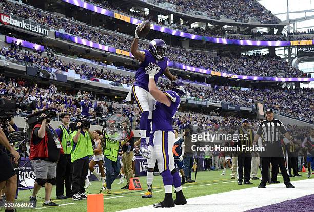 Jarius Wright and Jeremiah Sirles of the Minnesota Vikings celebrate after Wright scored a touchdown in the second quarter of the game against the...