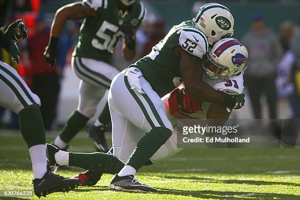 David Harris of the New York Jets tackles Jonathan Dowling of the Buffalo Bills during the second quarter at MetLife Stadium on January 1, 2017 in...