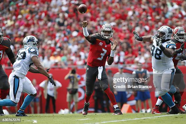 Quarterback Jameis Winston of the Tampa Bay Buccaneers throws to an open receiver while getting pressure from defensive back Leonard Johnson of the...