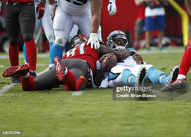 Defensive end Robert Ayers of the Tampa Bay Buccaneers sacks quarterback Cam Newton of the Carolina Panthers during the second quarter of an NFL game...