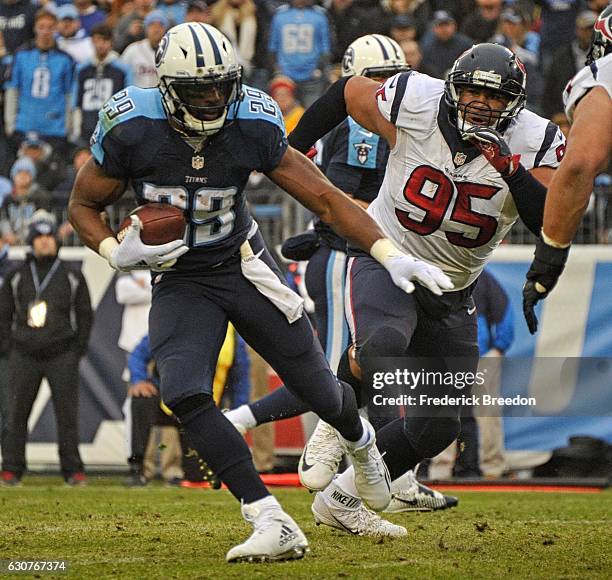 DeMarco Murray of the Tennessee Titans rushes past Christian Covington of the Houston Texans during the second half at Nissan Stadium on January 1,...