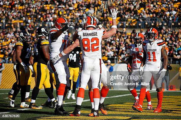 Gary Barnidge of the Cleveland Browns celebrates his 4 yard touchdown reception with teammates in the first half during the game against the...