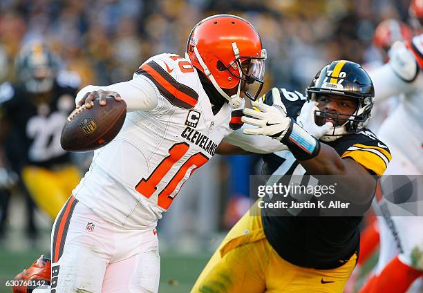 Robert Griffin III of the Cleveland Browns stiff arms Javon Hargrave of the Pittsburgh Steelers as he scrambles out of the pocket in the second half...