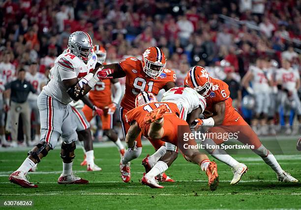 Ohio State Buckeyes running back Curtis Samuel is wrapped up by Clemson Tigers linebacker Dorian O'Daniel , defensive end Austin Bryant , and...