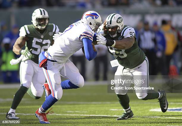 Buffalo Bills Quarterback EJ Manuel is wrapped up by New York Jets Nose Tackle Deon Simon during the NY Jets vs Buffalo Bills NFL football game on...