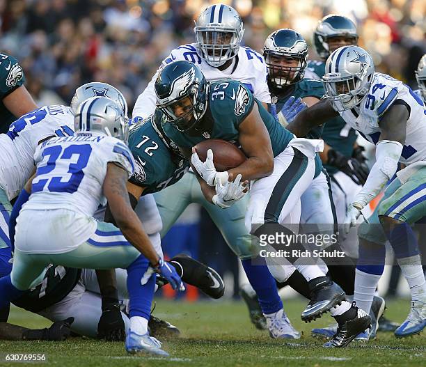 Terrell Watson of the Philadelphia Eagles runs with the ball as Leon McFadden and Randy Gregory of the Dallas Cowboys defend during the fourth...