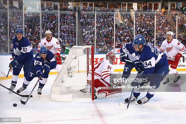 Stephane Robidas of the Toronto Maple Leafs looks to pass to teammate Auston Matthews during the first period of the 2017 Scotiabank NHL Centennial...