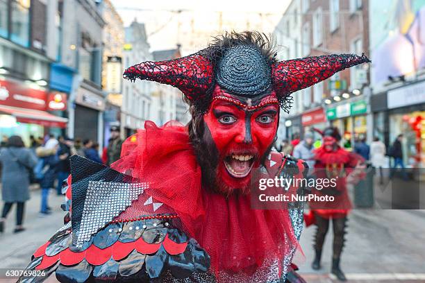 Member of the Dublin Circus Project dressed as devil performs on busy Dublin's Grafton Street on the New Year Day as a part of New Year's Festival on...