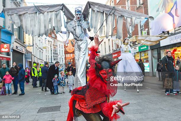 Members of the Dublin Circus Project dressed as angels and devils perform on Dublin's Grafton Street on the New Year Day as a part of New Year's...