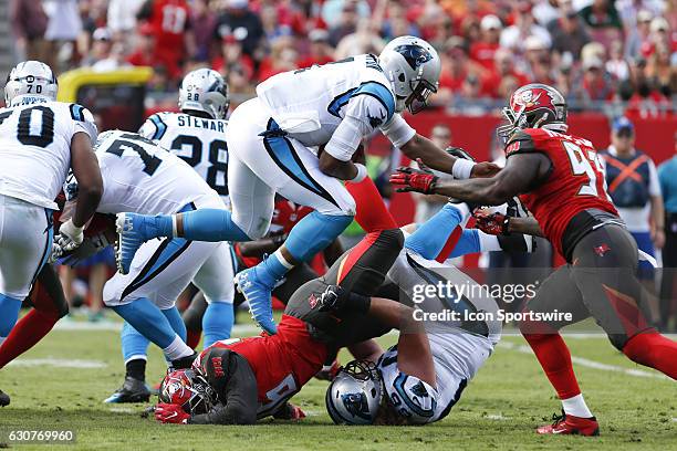 Carolina Panthers quarterback Cam Newton leaps over Tampa Bay Buccaneers defensive end Cliff Matthews and into the arm of Tampa Bay Buccaneers...