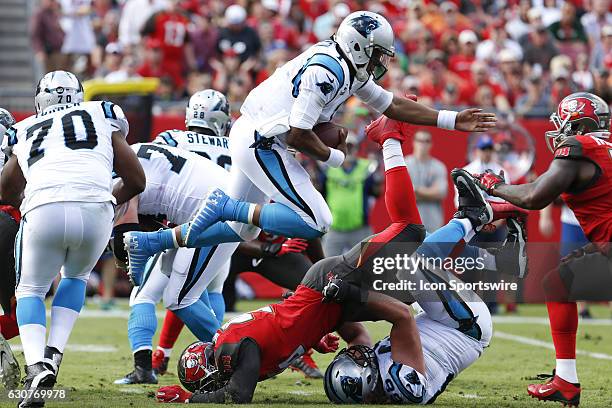 Carolina Panthers quarterback Cam Newton leaps over Tampa Bay Buccaneers defensive end Cliff Matthews well running the ball in the 2nd quarter of the...