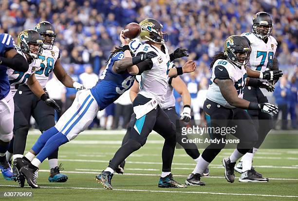 Blake Bortles of the Jacksonville Jaguars fumbles the ball as he is hit by Erik Walden of the Indianapolis Colts during the game at Lucas Oil Stadium...