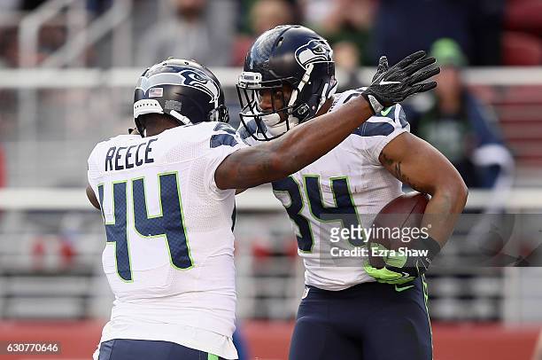 Thomas Rawls of the Seattle Seahawks is congratulated by Marcel Reece after he ran in for a touchdown against the San Francisco 49ers at Levi's...