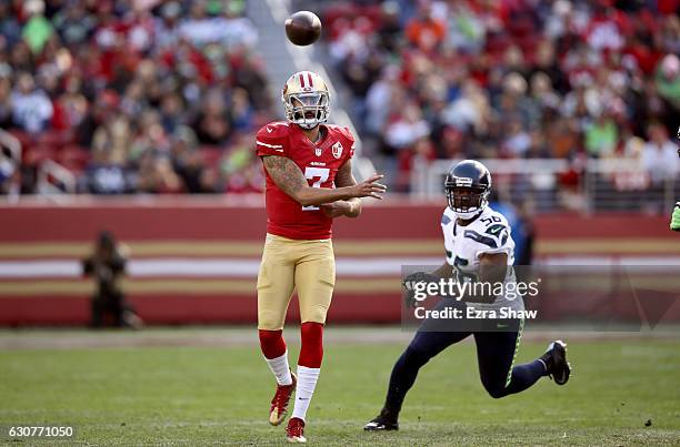 Colin Kaepernick of the San Francisco 49ers throws the ball while pressured by Cliff Avril of the Seattle Seahawks at Levi's Stadium on January 1,...