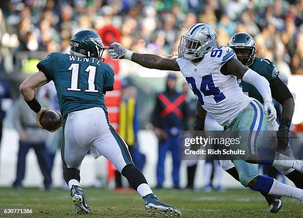 Quarterback Carson Wentz of the Philadelphia Eagles escapes Randy Gregory of the Dallas Cowboys during the third quarter of a game at Lincoln...