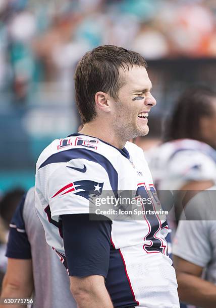 New England Patriots Quarterback Tom Brady laughs with New England Patriots Wide Receiver Chris Hogan on the bench during the final minutes of the...