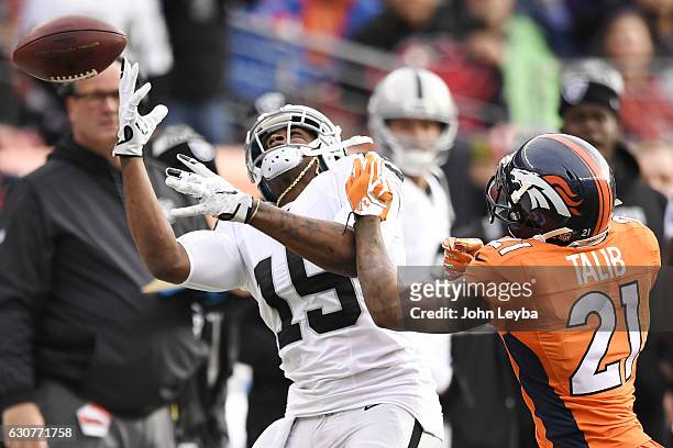 Michael Crabtree of the Oakland Raiders cannot haul in a pass as Aqib Talib of the Denver Broncos defends during the first quarter on Sunday, January...