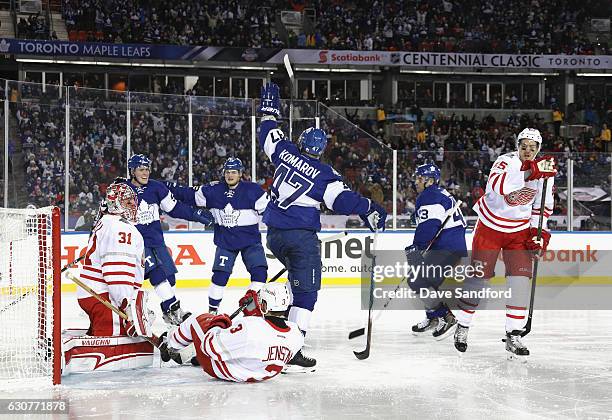 Leo Komarov of the Toronto Maple Leafs celebrates with teammates after scoring a goal on goaltender Jared Coreau of the Detroit Red Wings to tie the...