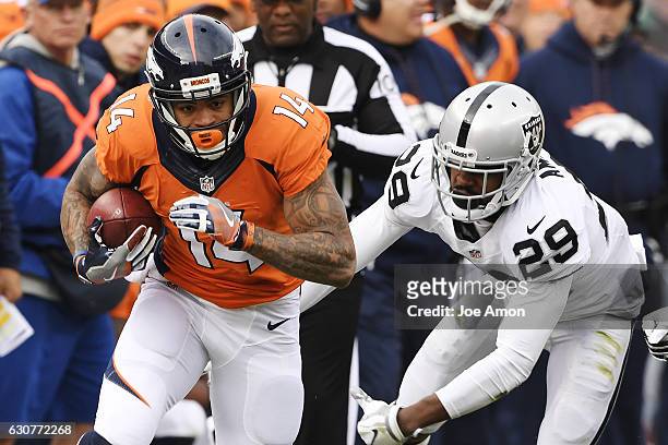 Cody Latimer of the Denver Broncos runs after breaking a tackle by David Amerson of the Oakland Raiders during the first quarter on Sunday, January...