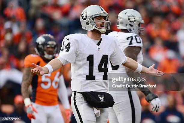 Quarterback Matt McGloin of the Oakland Raiders with his arms outstretched in the first quarter of the game against the Denver Broncos at Sports...