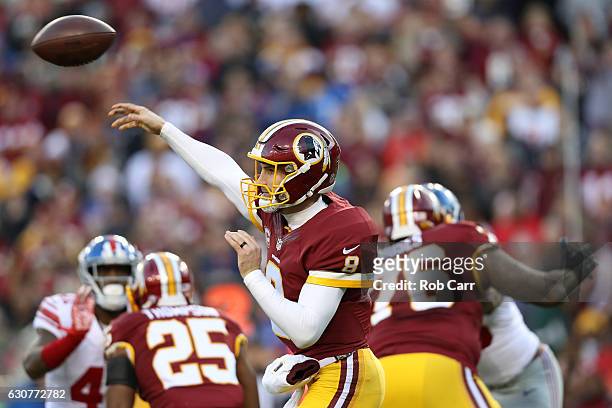 Quarterback Kirk Cousins of the Washington Redskins passes the ball while teammate running back Chris Thompson blocks against cornerback Dominique...