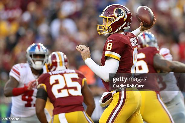 Quarterback Kirk Cousins of the Washington Redskins passes the ball while teammate running back Chris Thompson blocks against cornerback Dominique...