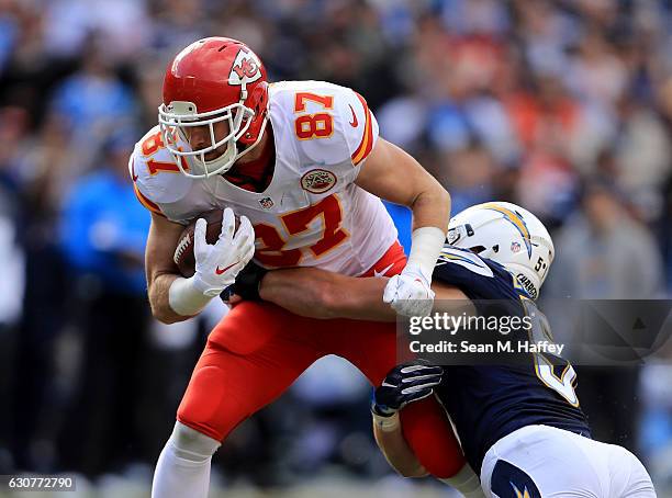 Travis Kelce of the Kansas City Chiefs runs through the defense of Kyle Emanuel of the San Diego Chargers during the first half of a game at Qualcomm...