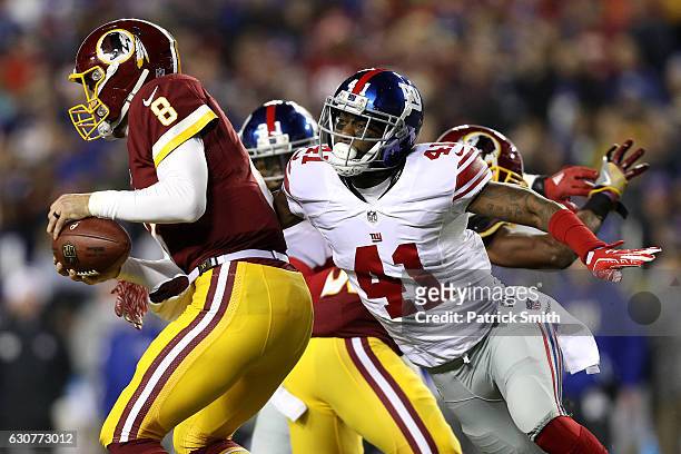 Quarterback Kirk Cousins of the Washington Redskins is sacked by cornerback Dominique Rodgers-Cromartie of the New York Giants in the second quarter...