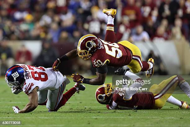 Wide receiver Sterling Shepard of the New York Giants is tackled by outside linebacker Martrell Spaight and free safety Will Blackmon of the...