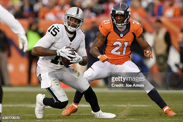 Michael Crabtree of the Oakland Raiders makes a catch as Aqib Talib of the Denver Broncos defends during the second quarter on Sunday, January 1,...