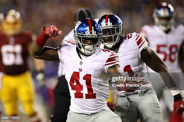 Cornerback Dominique Rodgers-Cromartie of the New York Giants reacts with teammate strong safety Landon Collins of the New York Giants after sacking...