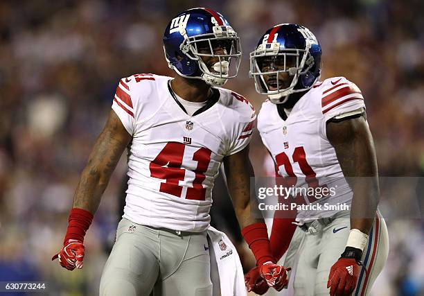 Cornerback Dominique Rodgers-Cromartie of the New York Giants reacts with teammate strong safety Landon Collins of the New York Giants after sacking...