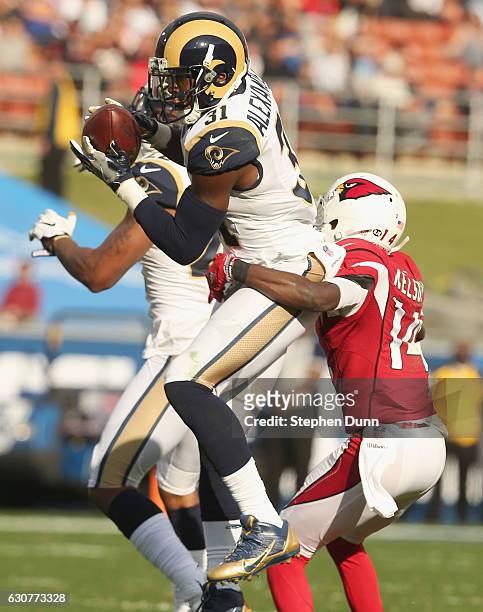 Safety Maurice Alexander of the Los Angeles Rams intercepts a pass intended for wide receiver J.J. Alexander of the Arizona Cardinals in the second...