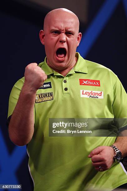 Michael van Gerwen of The Netherlands celebrates beating Raymond van Barneveld of The Netherlands in their semi-final on day fourteen of the 2017...