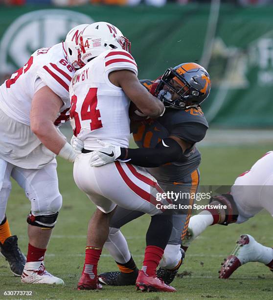 Todd Kelly, Jr. Tennessee Volunteers defensive back tackles Terrell Newby Nebraska Cornhuskers running back during the Franklin American Mortgage...