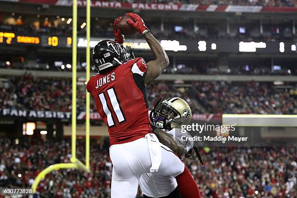 Julio Jones of the Atlanta Falcons catches a touchdown pass over B.W. Webb of the New Orleans Saints during the first half at the Georgia Dome on...