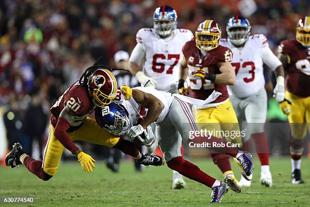 Wide receiver Sterling Shepard of the New York Giants is tackled by defensive back Greg Toler of the Washington Redskins in the second quarter at...