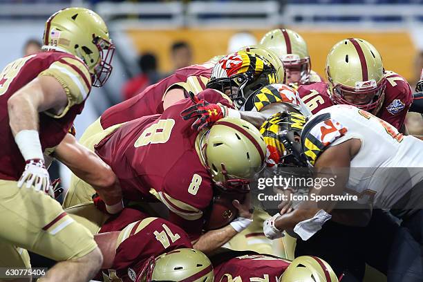 Boston College Eagles quarterback Patrick Towles attempts to cross the goal line during Quick Lane Bowl game action between the Boston College Eagles...