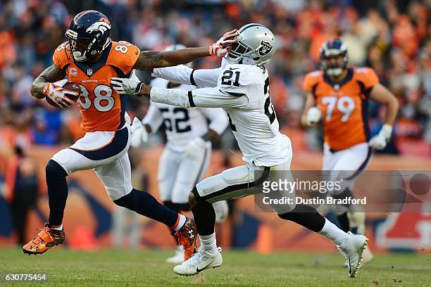 Wide receiver Demaryius Thomas of the Denver Broncos stiff arms cornerback Sean Smith of the Oakland Raiders in the third quarter of the game at...