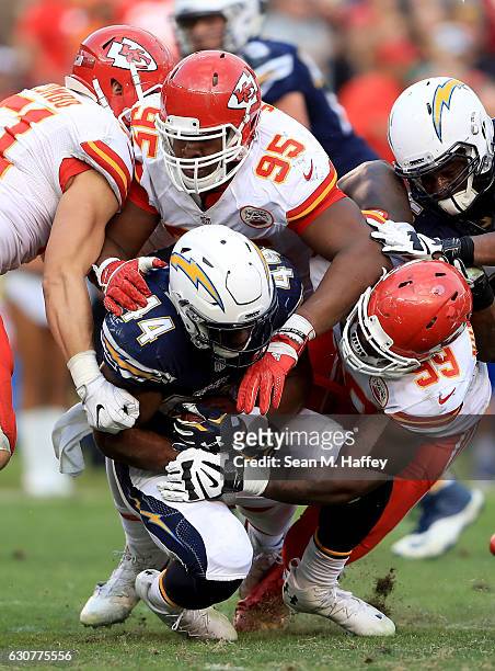 Andre Williams of the San Diego Chargers is smothered by Frank Zombo, Chris Jones and Rakeem Nunez-Roches of the Kansas City Chiefs during the second...