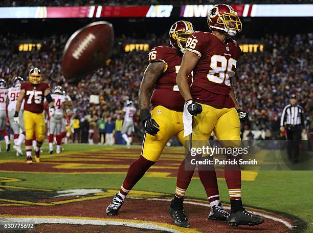 Tight end Jordan Reed of the Washington Redskins celebrates with teammate tackle Morgan Moses after scoring a fourth quarter touchdown against the...